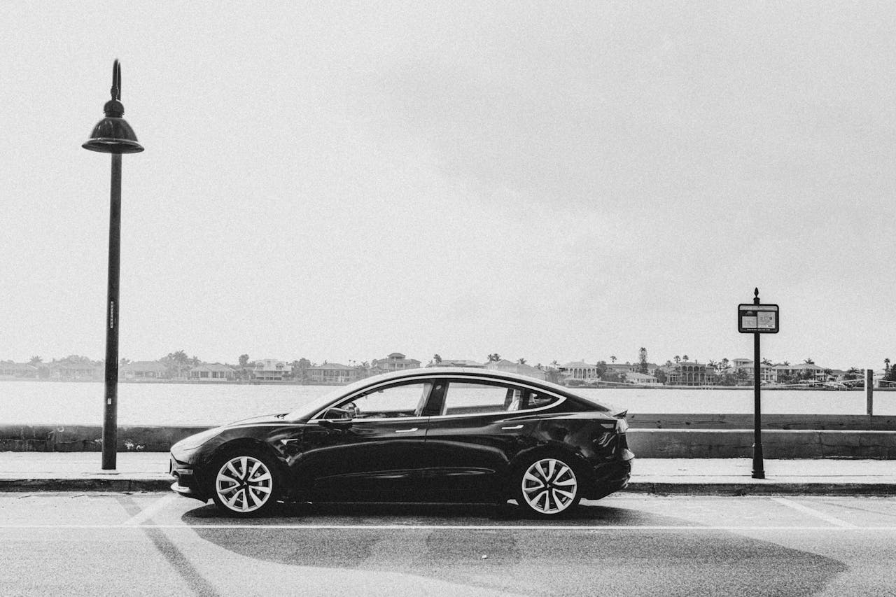 Black and white photo of a tesla car on the street